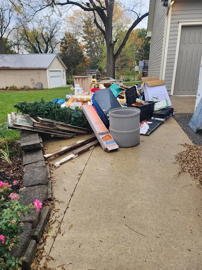 Dumpster being loaded with debris for 10 Yard Dumpster Rental in Freetown